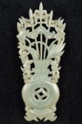 An unmarked silver and carved jade brooch Formed as a flowering vase. 8.5 cm high.