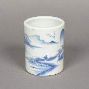 A Chinese blue and white porcelain brush pot Decorated with a figure fishing in a continuous river