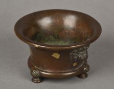 A small Chinese gold splash patinated bronze censor Of squat flared form with twin mask,