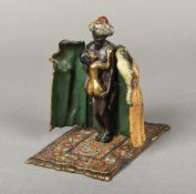An erotic cold painted bronze figure Modelled as a portly Arab stroking a cat,