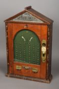 A mahogany cased Patent Tivoli Penny Skill Test machine The triangular glazed top section with