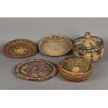 Two Native American Indian woven lidded baskets Together with two shallow bowls; and a plaque,