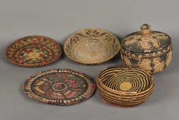 Two Native American Indian woven lidded baskets Together with two shallow bowls; and a plaque,