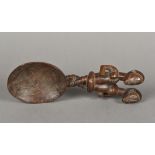 An unusual tribal carved wooden spoon The handle carved as entwined male and female figures with