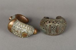 Two Benin cast and pierced bronze bracelets Of typical form. The largest 15.5 cm wide.