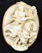 A unmarked gold framed carved white coral brooch Carved as a woman holding a laurel wreath and a