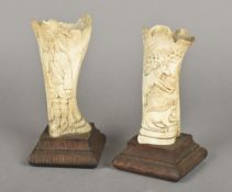 A pair of 19th century Central European carved bone vases One worked with a huntsman,