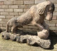 A Chinese carved pink granite model of a dog Modelled standing with his front paws on a ball,