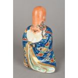 Two Chinese porcelain figures One formed as Shou Lao holding a scroll,