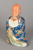 Two Chinese porcelain figures One formed as Shou Lao holding a scroll,