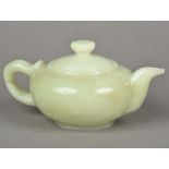 A jade teapot Of typical squat form. 15 cm wide.