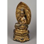 A lacquered carved wooden model of Buddha Modelled seated in the lotus position above a stepped