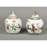 A pair of Chinese porcelain vases and covers Polychrome decorated with boys in various pursuits,