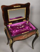 A 19th century boulle lady's work table The ormolu mounted hinged serpentine rectangular top