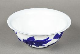 A Chinese Peking glass bowl Worked with fish and aquatic plants on a white ground. 16 cm diameter.