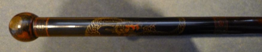 A Chinese metal inlaid and decorated walking cane Worked with a dragon. 91.5 cm long.