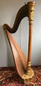 A late 19th/early 20th century American gilt and satinwood harp The brass side plate inscribed The