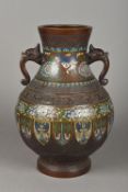 A large late 19th century Chinese cloisonne decorated bronze vase Of bulbous form with twin mask