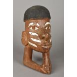 A Solomon Islands carved wooden head With painted hair and inlaid with mother-of-pearl. 21 cm high.