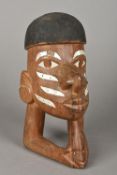 A Solomon Islands carved wooden head With painted hair and inlaid with mother-of-pearl. 21 cm high.