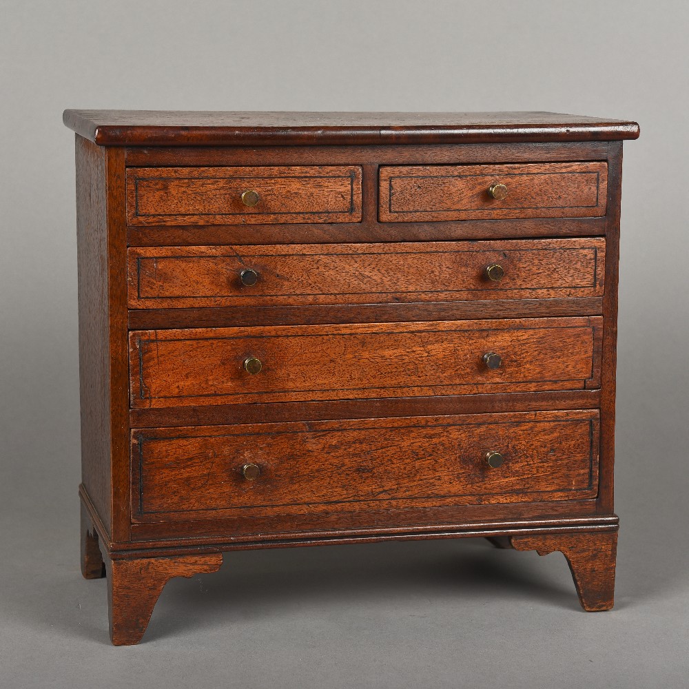 A 19th century mahogany miniature chest of drawers With two short over three long graduated drawers,