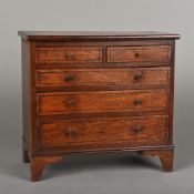 A 19th century mahogany miniature chest of drawers With two short over three long graduated drawers,