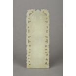 A Chinese carved celadon jade tablet Worked with precious objects within a pierced border.