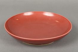 A Chinese porcelain dish With allover red glaze,