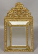 A 19th century Continental pressed brass wall glass The central bevelled mirror plate flanked by