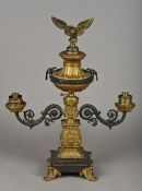 An ormolu and patinated bronze candelabra Surmounted with eagles and with twin scrolling branches.