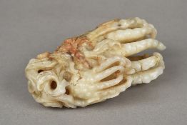 A large Chinese carved celadon and russet jade group Worked as Buddha's fingers. 13.5 cm long.