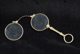 A pair of bi-colour gold framed lorgnettes Of typical form with pull catch and loop handle. 9.