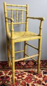 A Regency painted faux bamboo child's correction chair Of typical tall upright form,