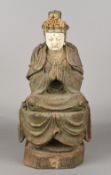 A Chinese 18th/19th century carved wood and polychrome decorated figure of Guanyin Modelled praying