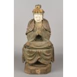 A Chinese 18th/19th century carved wood and polychrome decorated figure of Guanyin Modelled praying