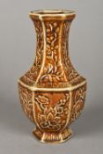 A Chinese treacle glazed porcelain vase Of hexagonal form, with scrolling floral decorations,