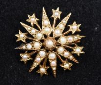 An Edwardian 9 ct gold and seed pearl pendant/brooch Of starburst form. 3.75 cm diameter.