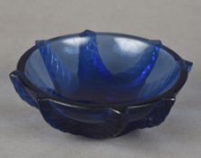 A small Lalique blue glass bowl The underside inscribed Lalique France. 11 cm diameter.