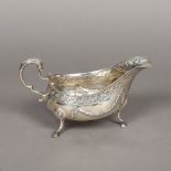 An Irish silver sauceboat, marks indistinct, maker's mark of MW Of large size,