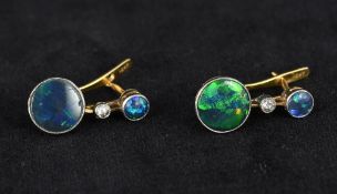 A pair of 10 kt gold opal and diamond earrings Set with two cabochon opals flanking a single