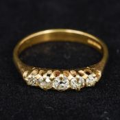 An 18 ct gold five stone diamond ring Of navette form, the central stone approximately 1/8th carat.