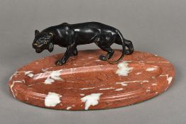 An Art Deco bronze mounted variegated marble desk stand The oval pen tray surmounted with the