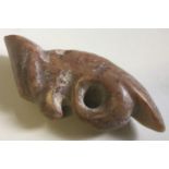 A South American carved green and russet jade pendant Worked as a bird. 7 cm long.