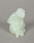 A Chinese carved jade model of a monkey Naturalistically modelled seated. 5.5 cm high.