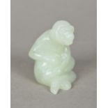 A Chinese carved jade model of a monkey Naturalistically modelled seated. 5.5 cm high.