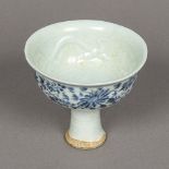 A Chinese porcelain stem cup The interior relief decorated with dragons,