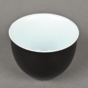 A Chinese porcelain tea bowl The exterior decorated with a black glaze,