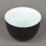 A Chinese porcelain tea bowl The exterior decorated with a black glaze,