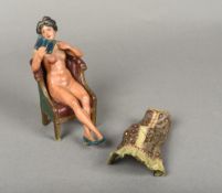 An erotic cold painted bronze figure Modelled as a sophisticated lady seated in a library chair