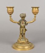 A 19th century ormolu twin branch candelabra The stem formed as a young faun,